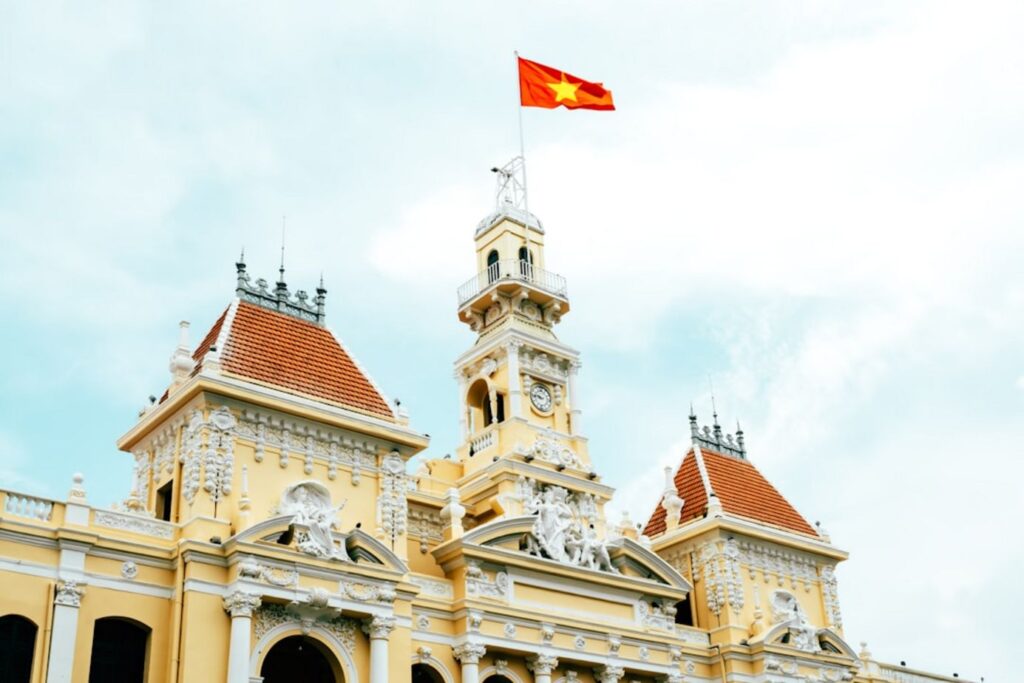 The vietnamese flag flies atop a building.-Hanoi Vietnam