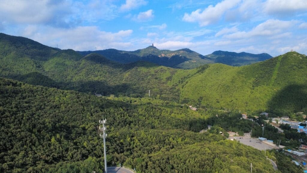 Mountains rise under a partly cloudy sky.-Hallasan National Park South Korea