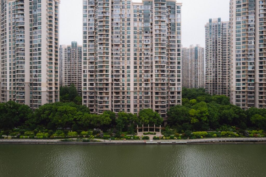 Apartment buildings line a body of water.-Shenzhen China