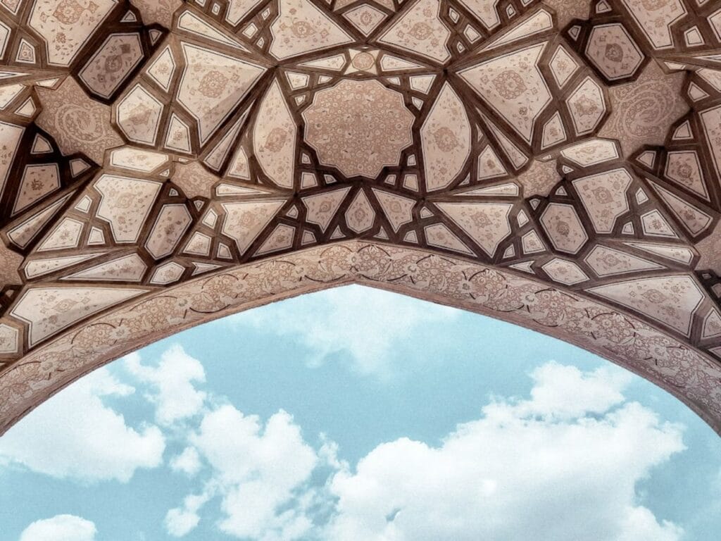 Intricate geometric ceiling pattern against a blue sky-Nurata Uzbekistan
