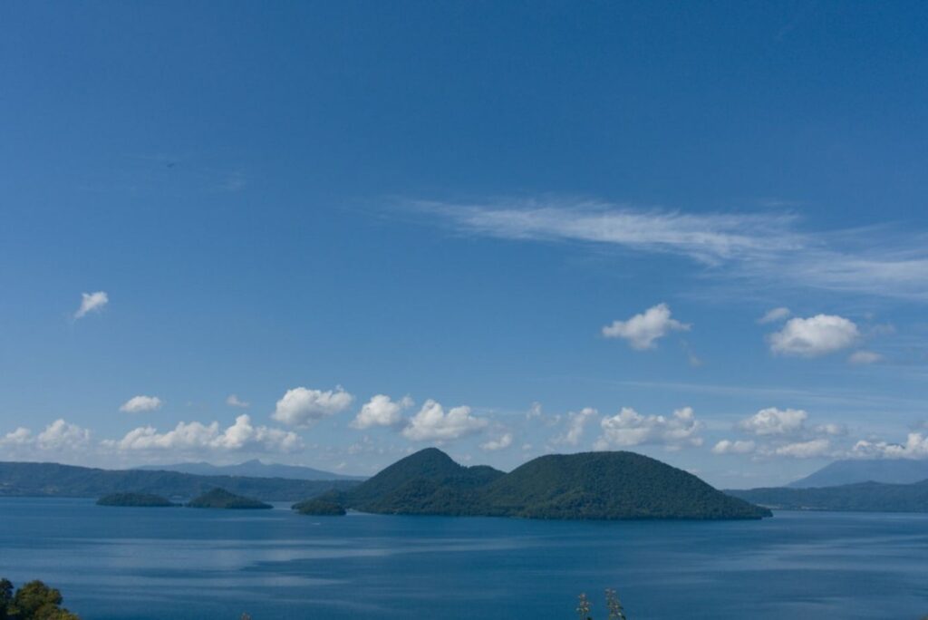 Islands on a calm blue lake under a cloudy sky-Azerbaijan islands
