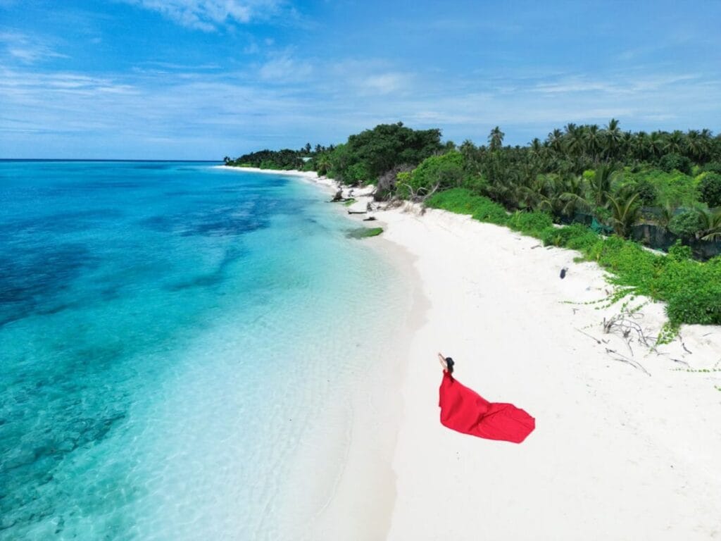 Woman in red dress on a tropical beach-Yas Island United Arab Emirates