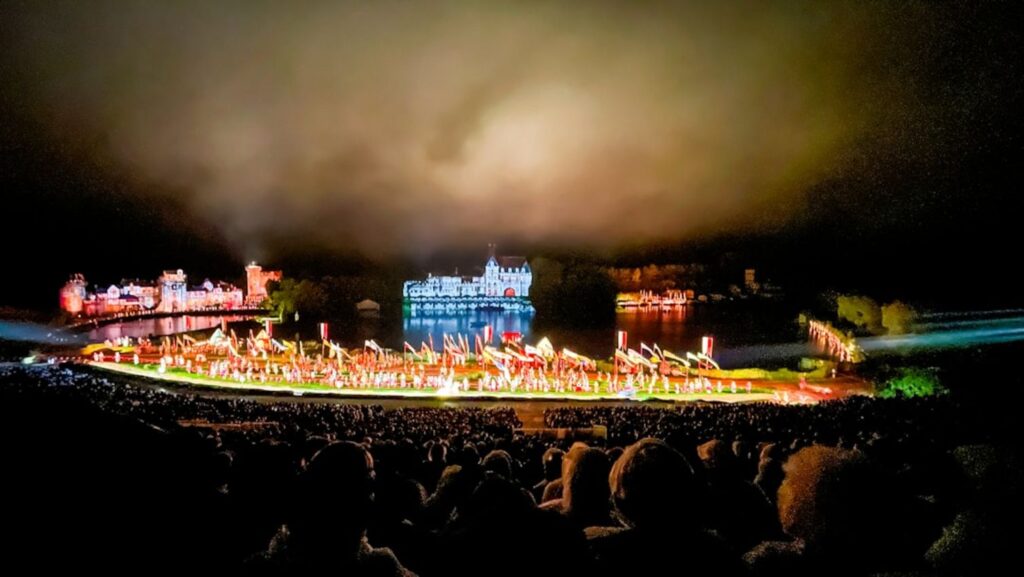 Large outdoor performance with illuminated buildings and crowd.-Azerbaijan festivals