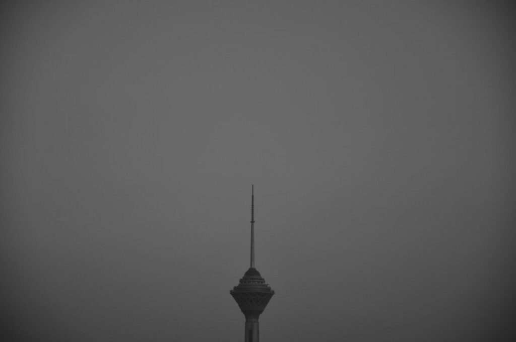 A tall tower piercing a foggy sky-United arab emirates weather