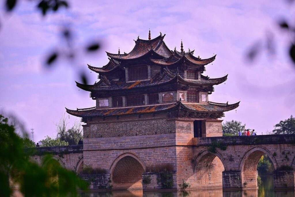 Traditional chinese bridge with ornate pagoda structure-China river