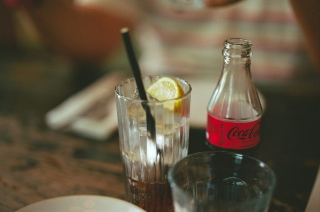 Glass of iced tea with lemon and coca-cola bottle-georgia food and drinks