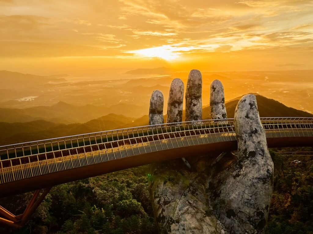 Golden bridge held by giant stone hands at sunset-vietnam mountain