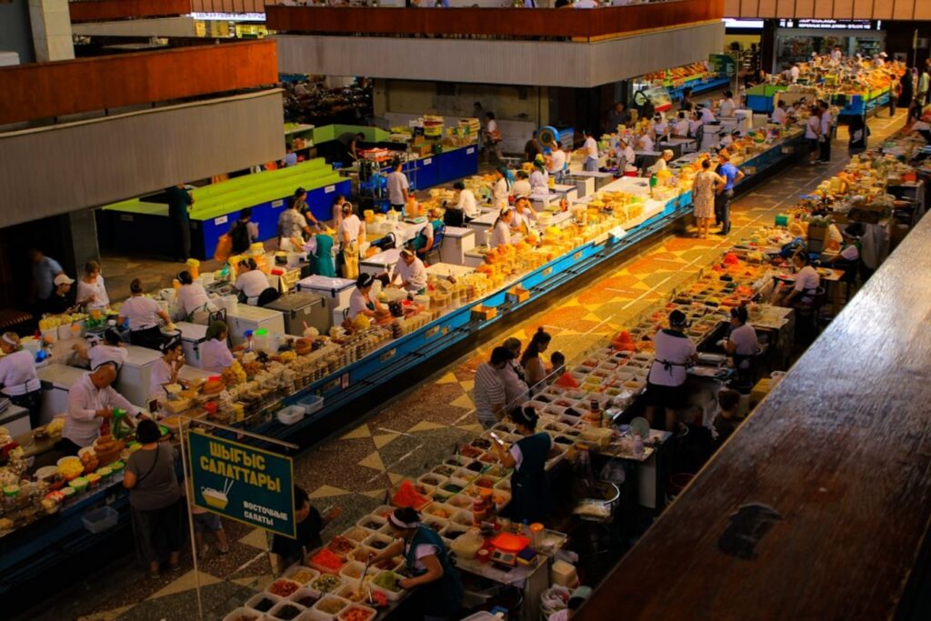 A busy market is filled with vendors and customers.-Kazakhstan food and drinks