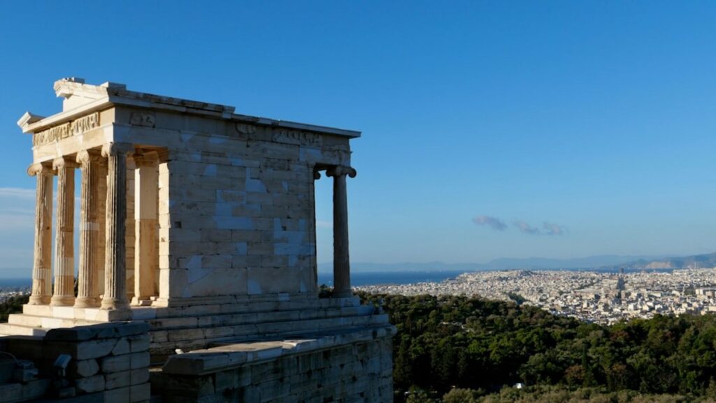 Ancient temple ruins overlooking a sprawling city below.-sorong Indonesia
